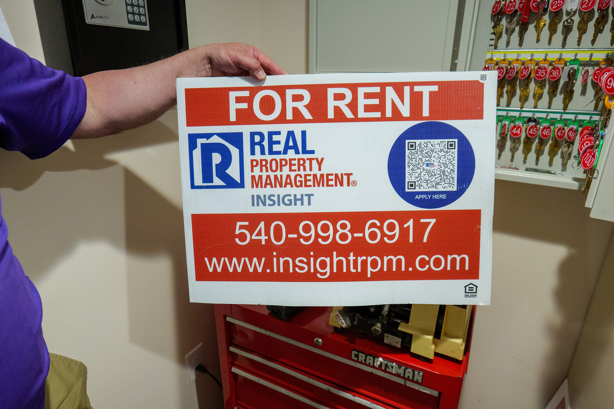 Real Property Management sign with the Scanlily QR code.